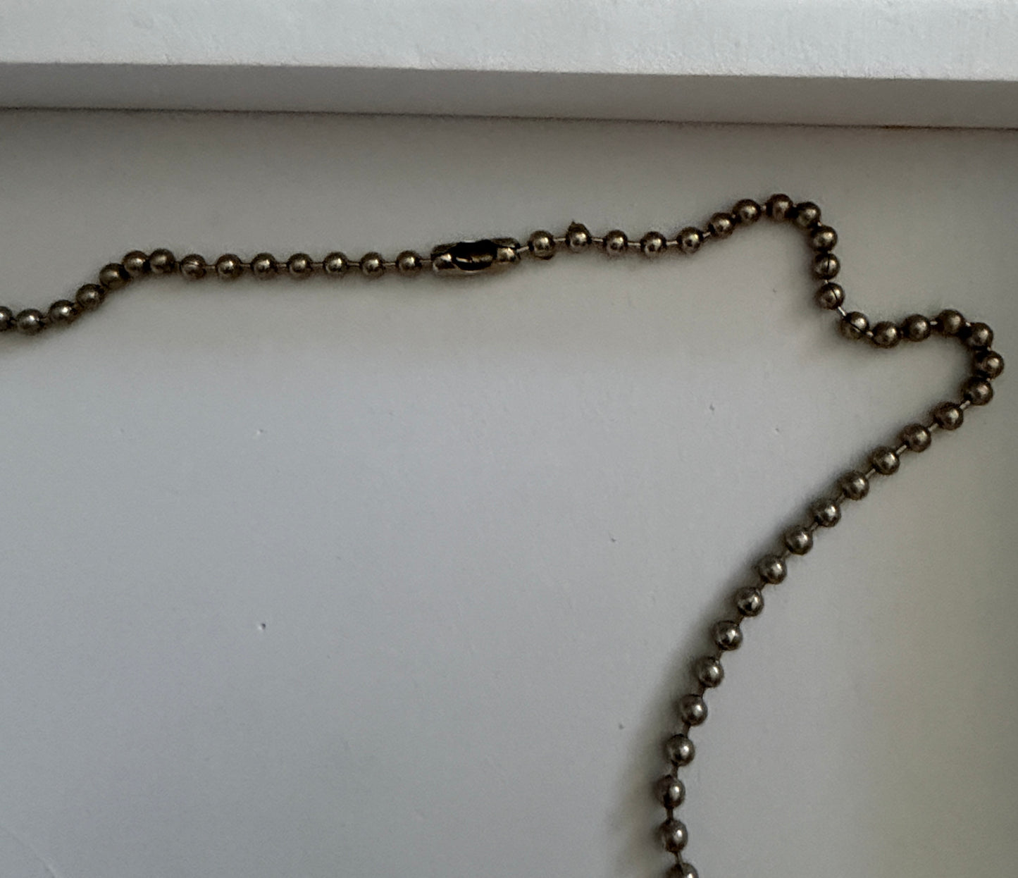 Metallic chain on a white surface