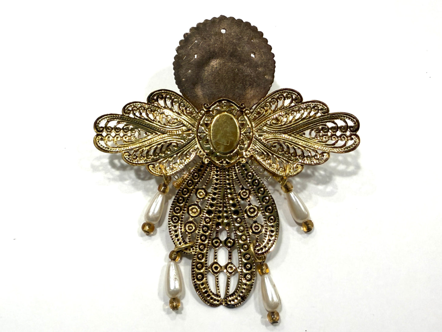 Decorative filigree gold and bronze details on the verso