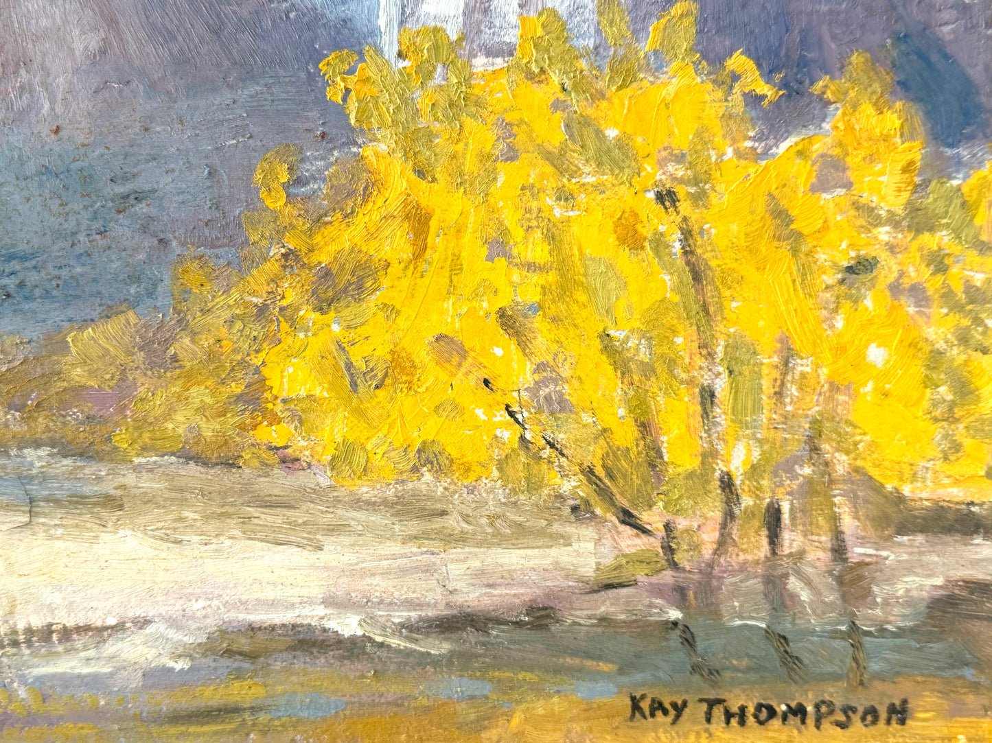 An impressionistic painting of a bright yellow tree in a landscape, signed 'Kay Thompson' in the bottom right corner.