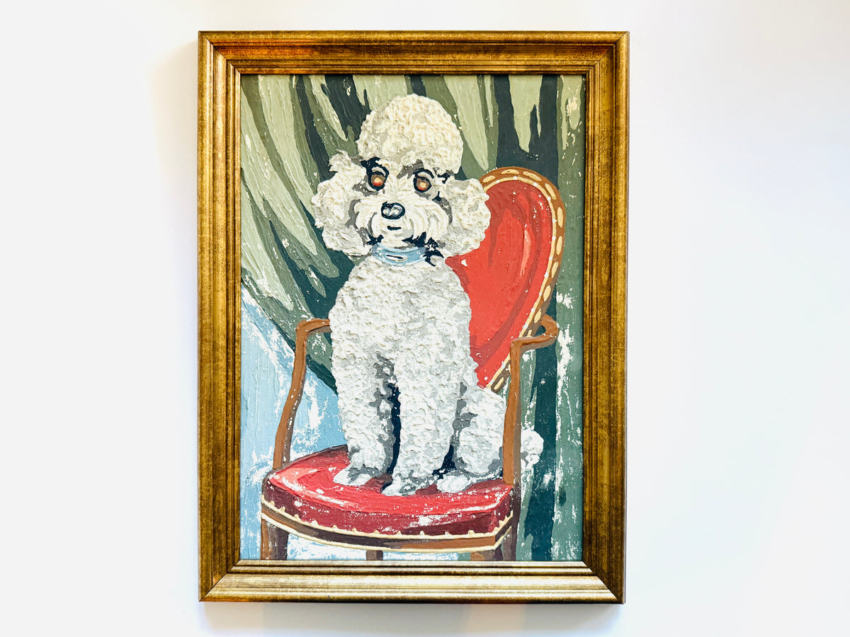 A painting of a white poodle sitting on a red chair features a textured impasto style, with a gold frame.