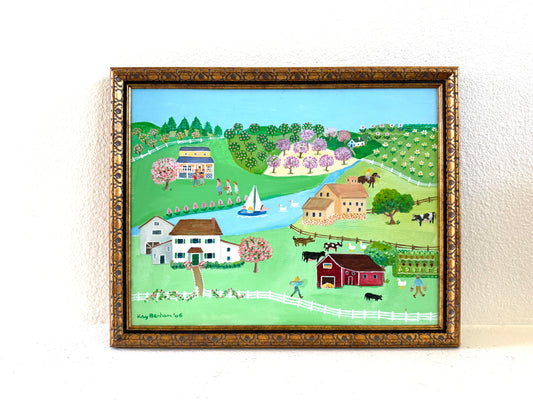 A framed folk art landscape painting depicting a rural scene with houses, barns, trees, fields, and a river Signed Kay Benham 06