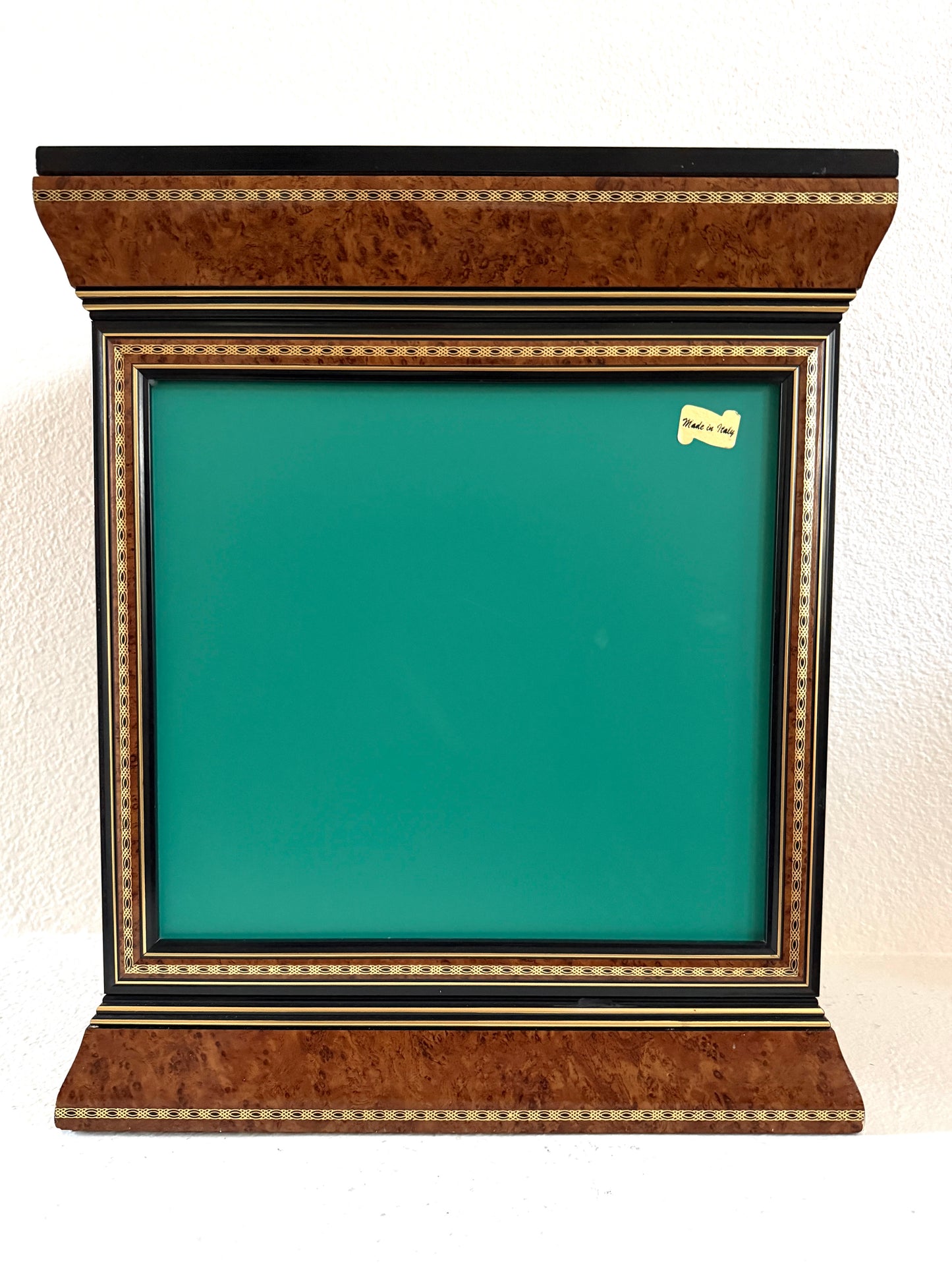 A vintage-style display cabinet with two glass doors, featuring a rich brown burl wood veneer, black trim, gold geometric inlay, and gold tassels on the door handles made in Italy