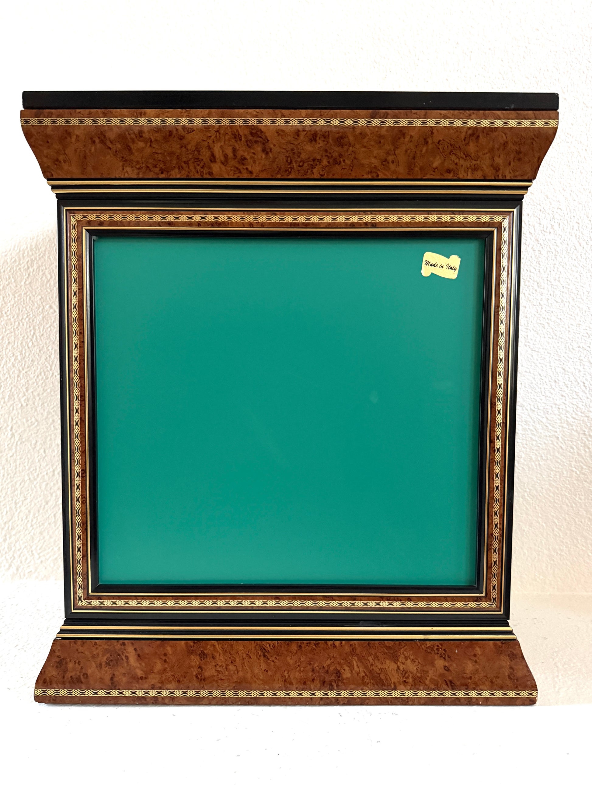 A vintage-style display cabinet with two glass doors, featuring a rich brown burl wood veneer, black trim, gold geometric inlay, and gold tassels on the door handles made in Italy