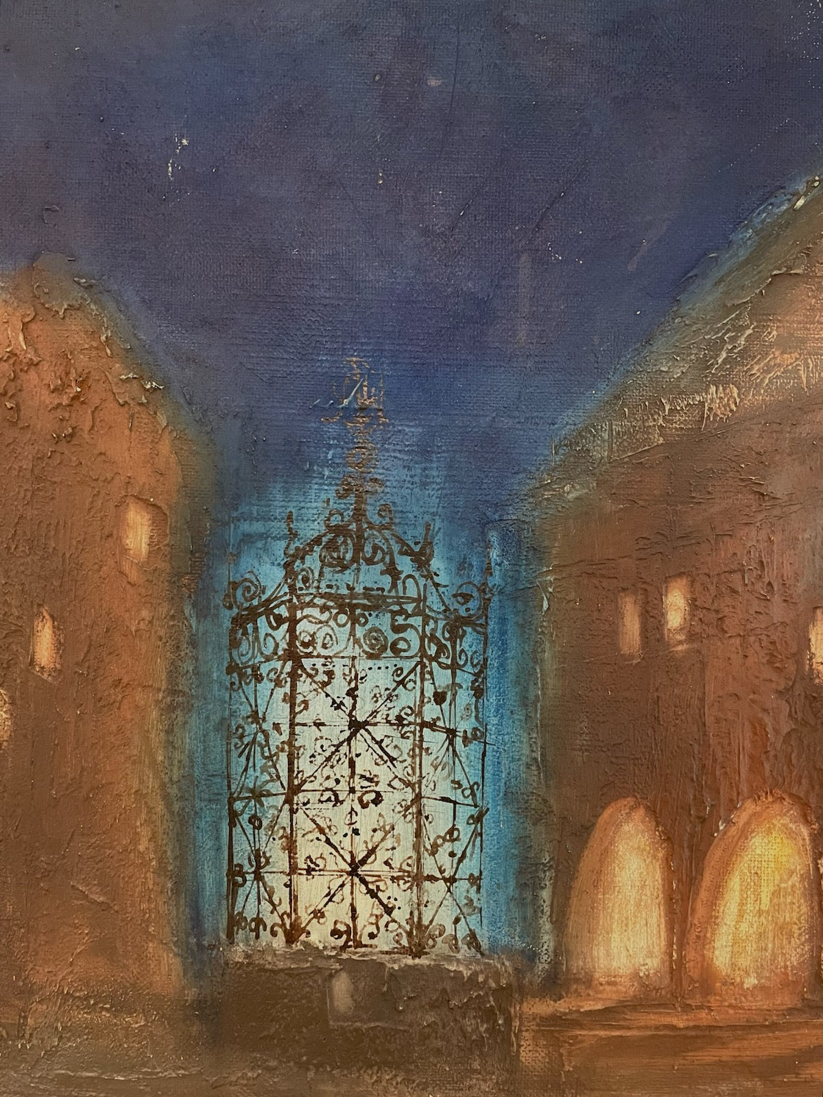 Decorative metal gate in a stone archway with a blue light effect signed Ivi Soukup 66