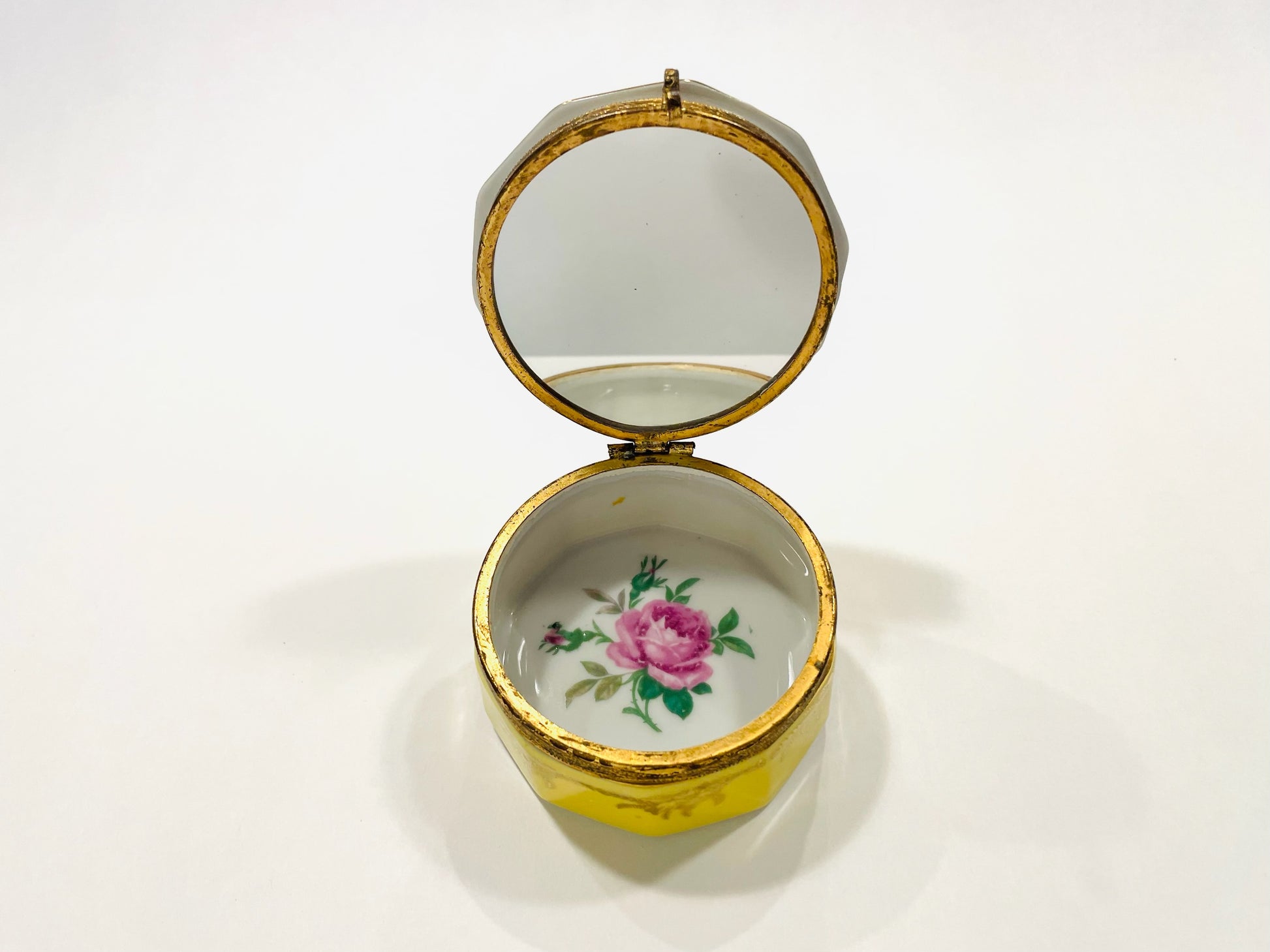 Decorative yellow box with floral design on a white background