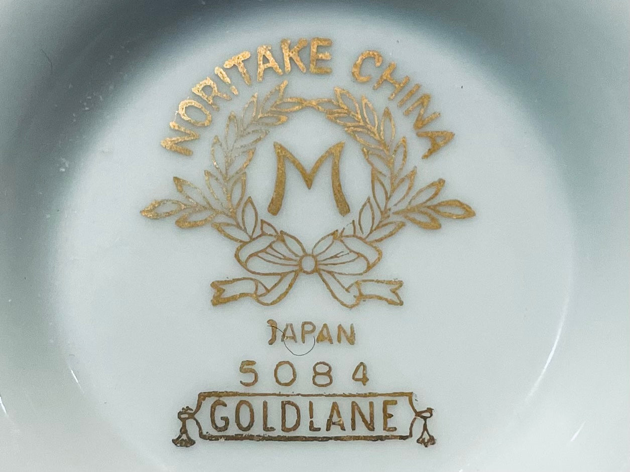 Narita China logo with 'M' and text on a white background