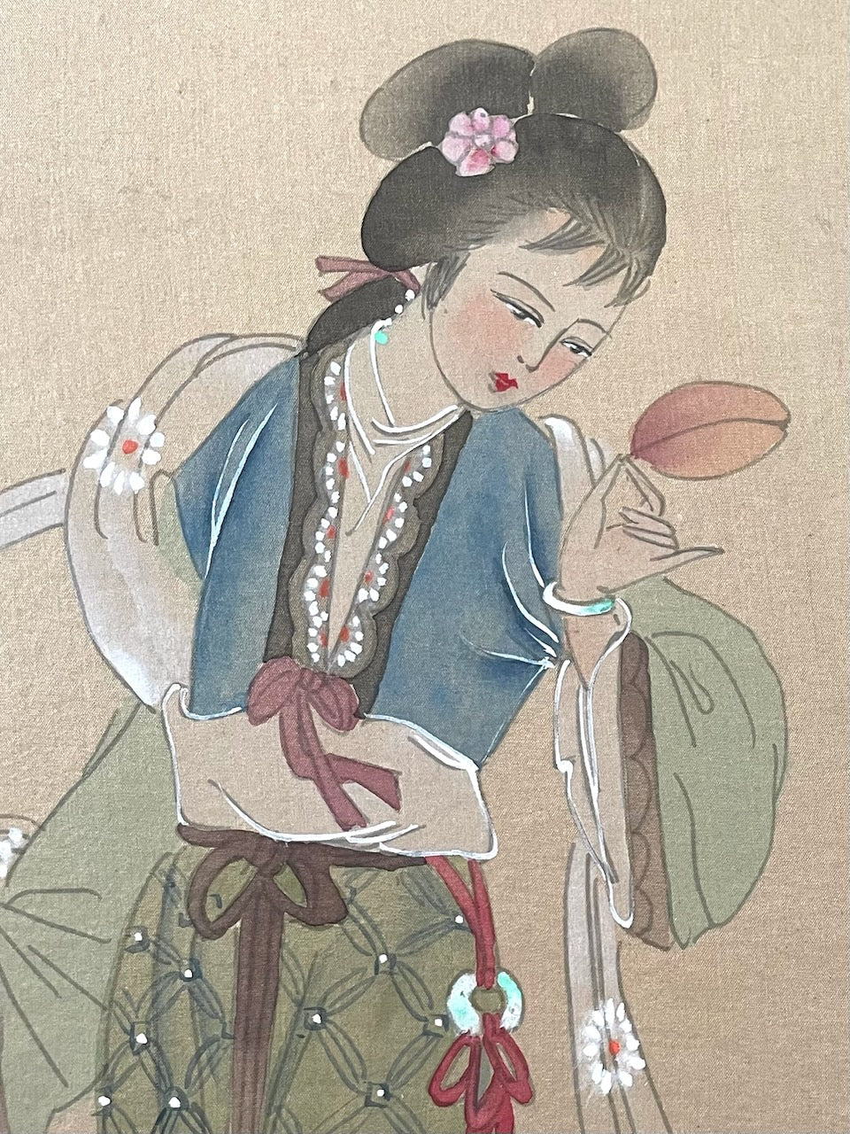 Traditional Chinese illustration of a woman holding a leaf