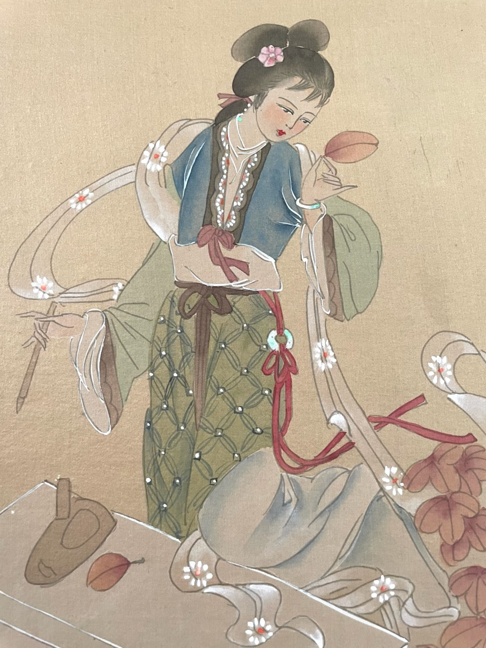 Traditional Chinese painting of a woman in classical attire with flowers and ribbons.