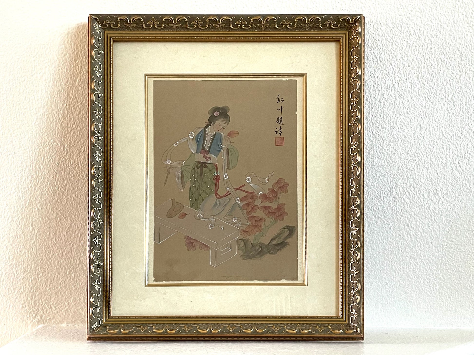Framed traditional Chinese painting of a woman with decorative gold frame.