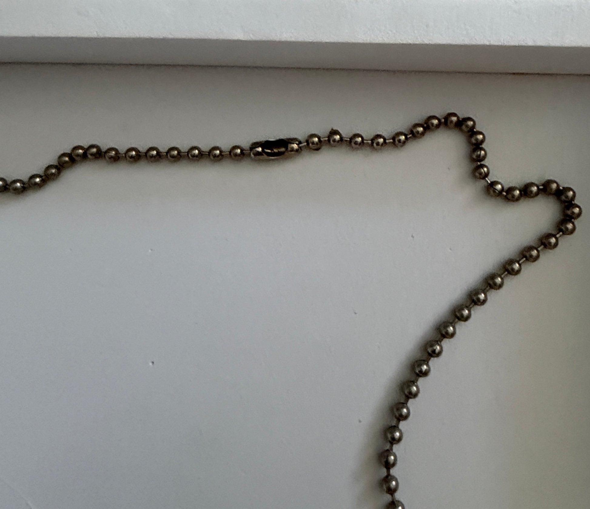 Metallic chain on a white surface