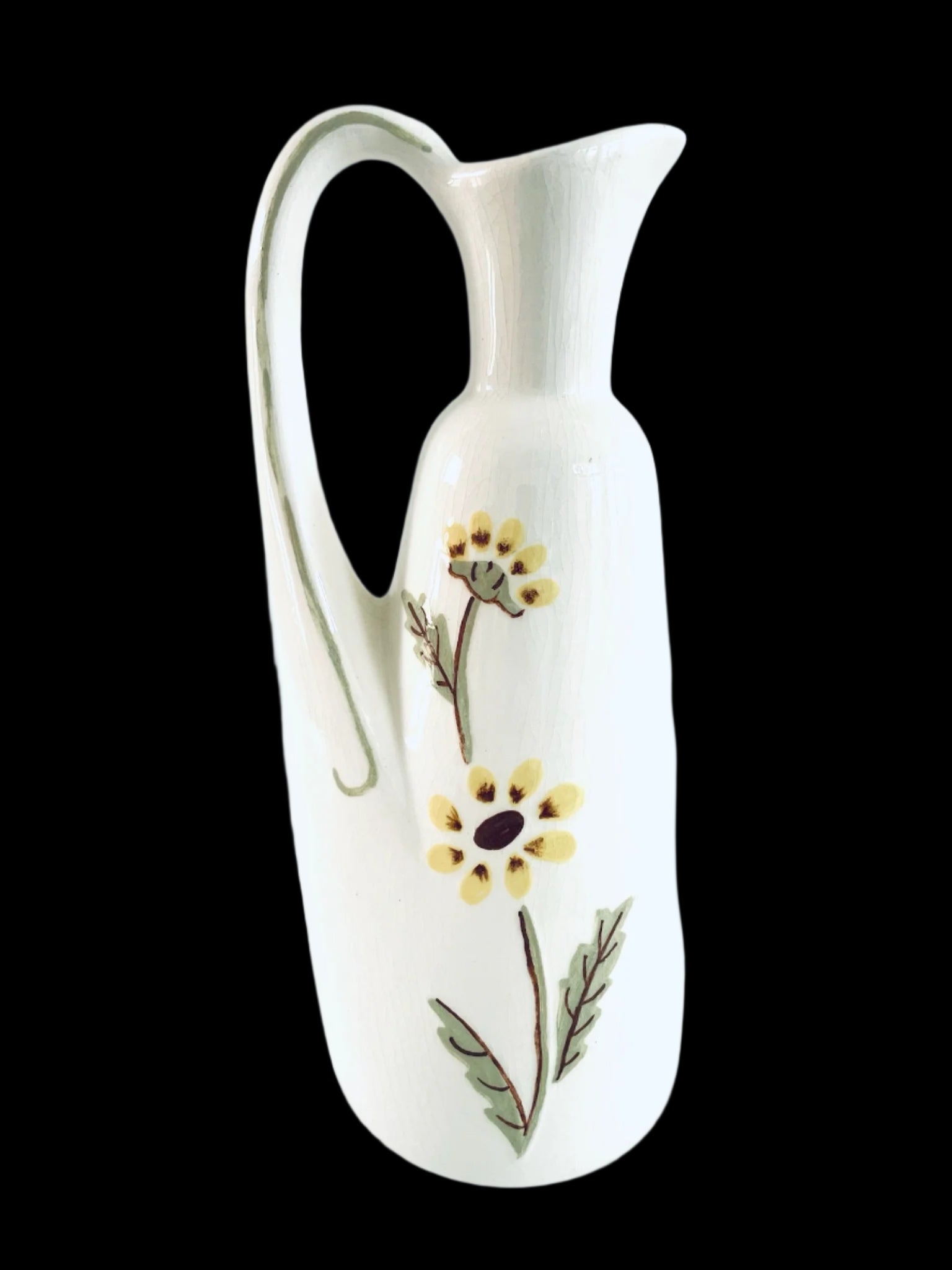 White ceramic pitcher with floral designs o
