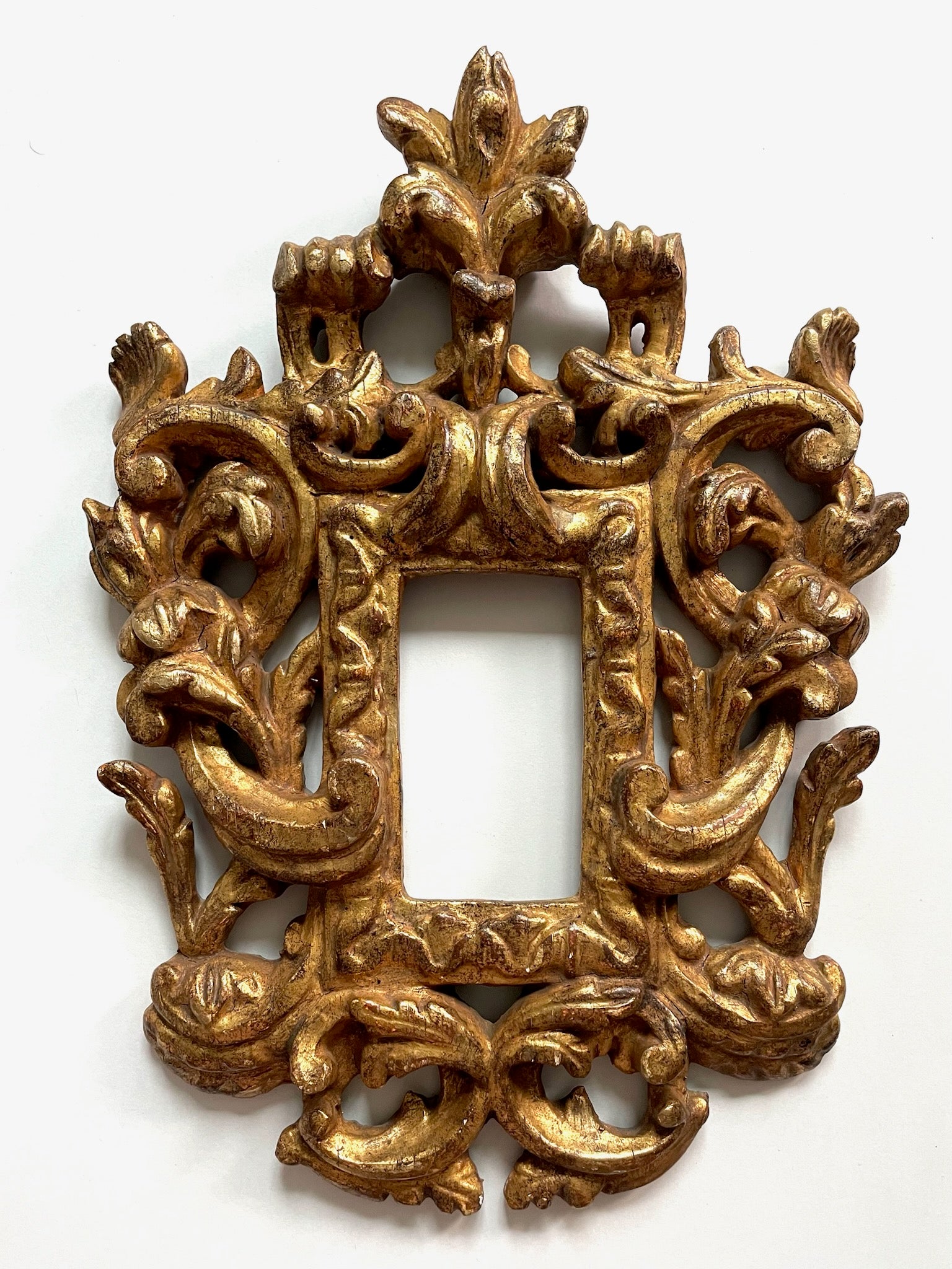 Decorative gold frame with intricate designs on a white background