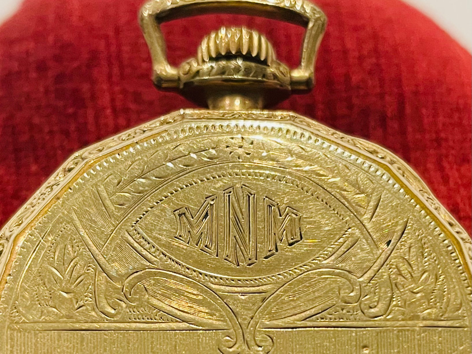 Close-up of a gold Elgin pocket watch with engraved design 