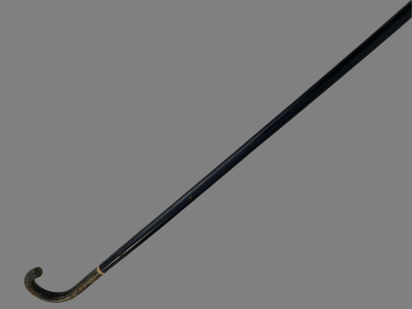 Black cane on a light gray background