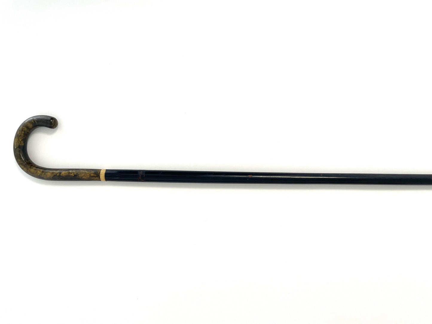 Black walking cane with a curved tortoise style handle 