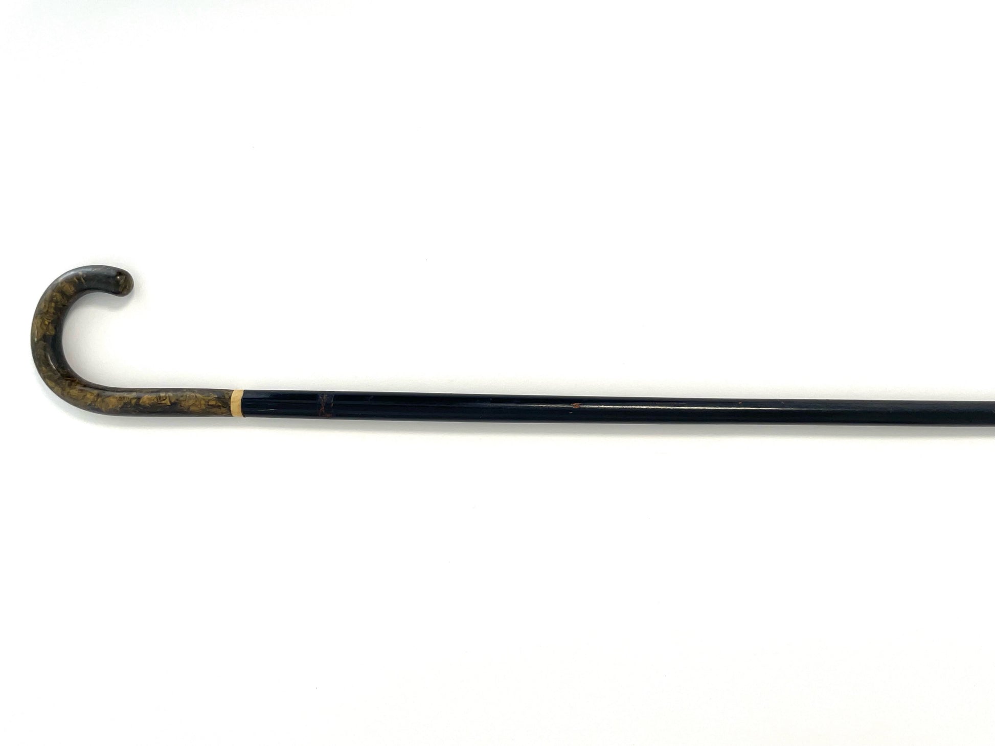 Black walking cane with a curved tortoise style handle 