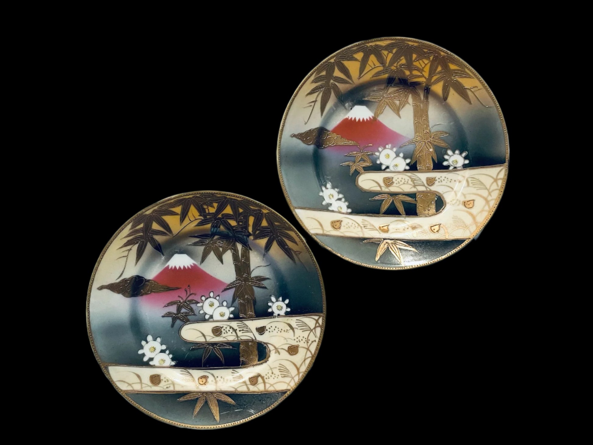 Two decorative plates with artistic Mount fuji  gold bamboo designs 