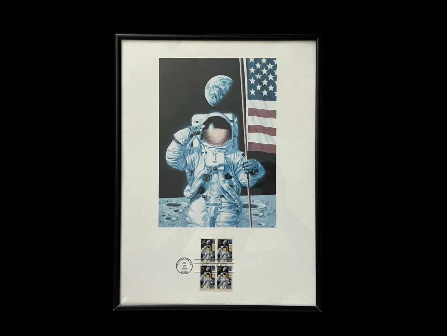 Framed artwork of an astronaut on the moon with an American flag and celestial elements.