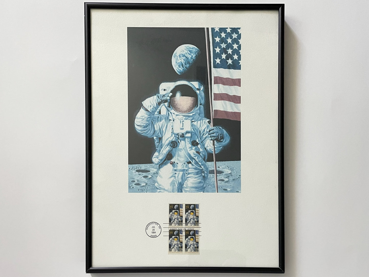 Framed artwork of an astronaut on the moon with a U.S. flag
