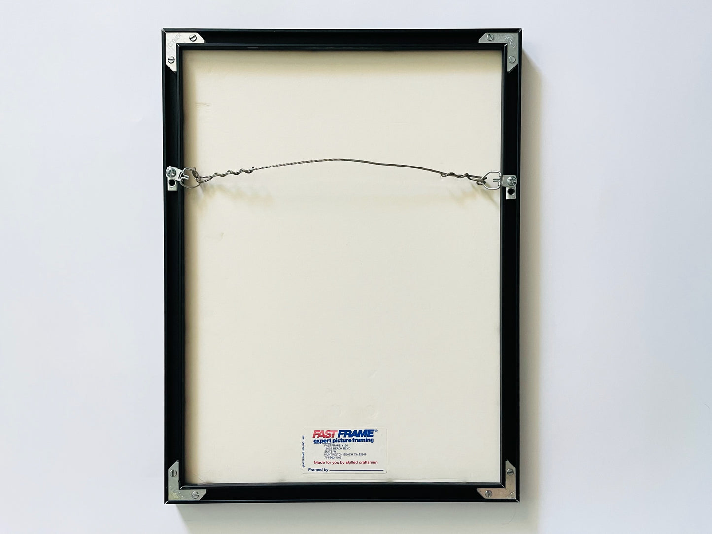 Black picture frame with a Fast Frame label on a white background