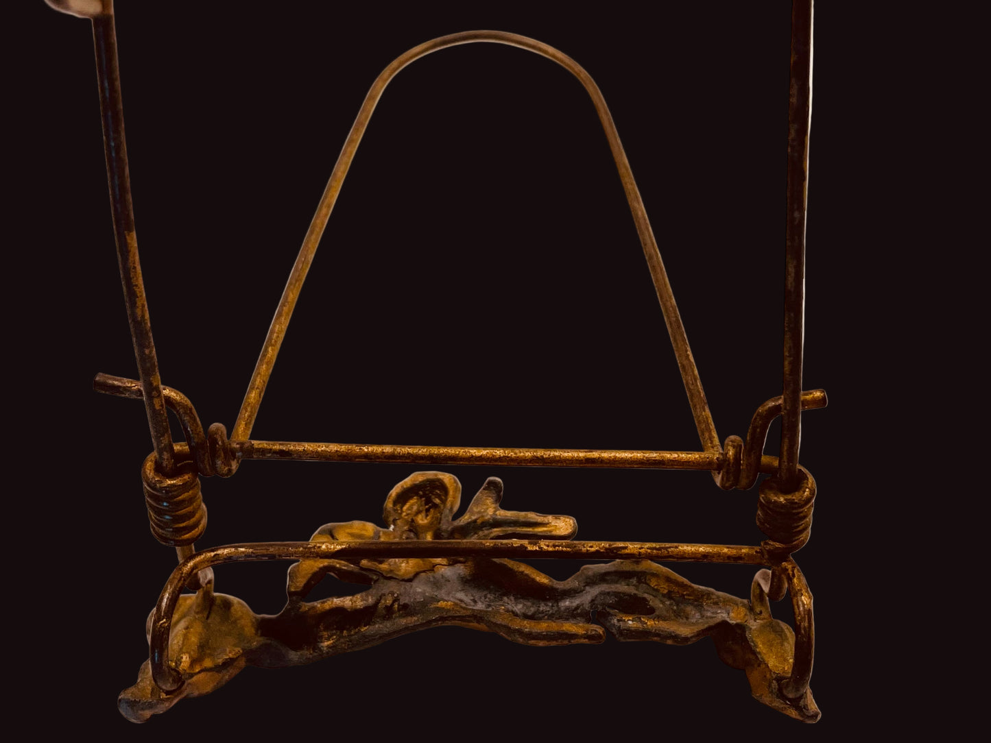Decorative metal stand with intricate design on a white background