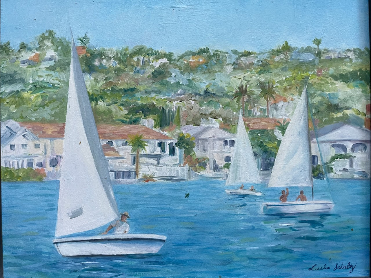 Leslie Schultz Sailing scene with sailboats on a body of water, with houses and trees in the background oil on canvas 
