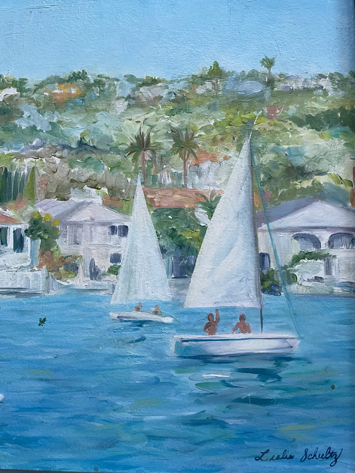 Leslie Schultz Sailing scene with sailboats on a body of water, with houses and trees in the background oil on canvas 
