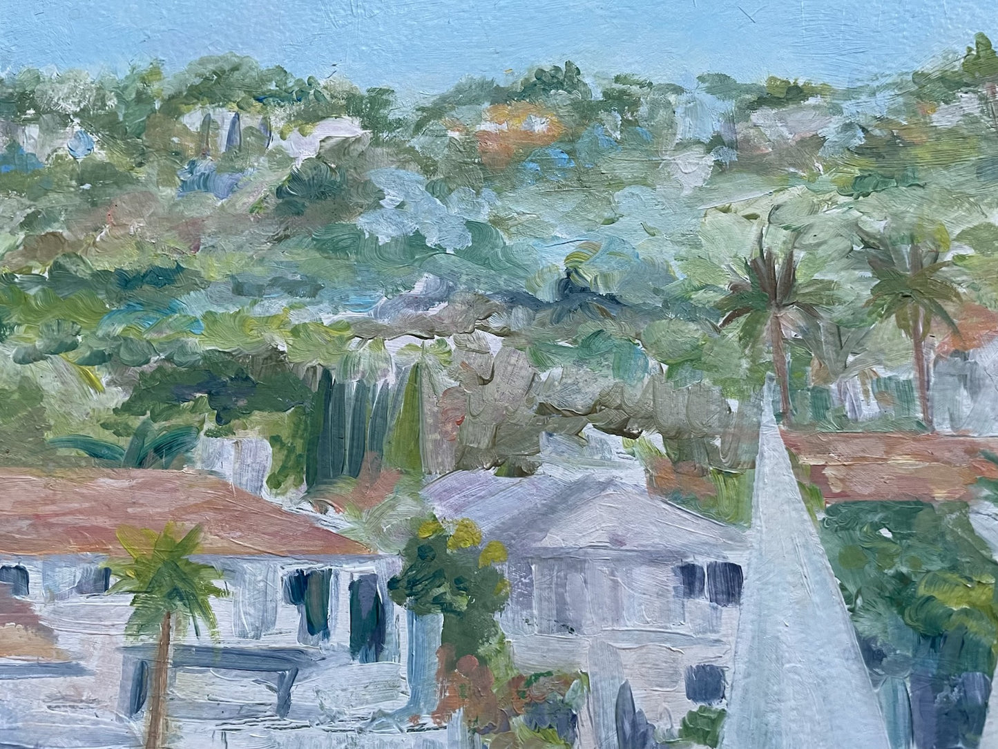 Painting of a tropical landscape with houses, trees, and a church steeple.