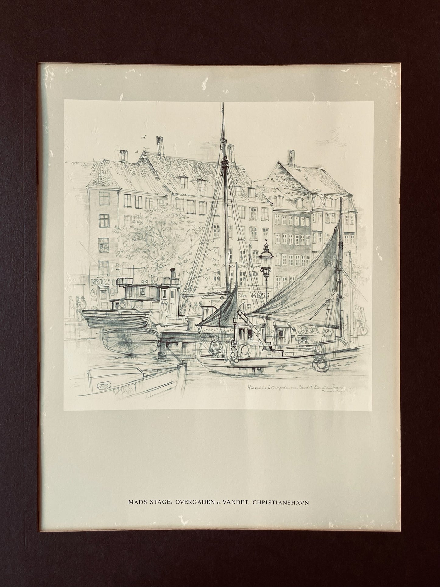 Black and white drawing of a harbor scene with buildings and boats on a plain background