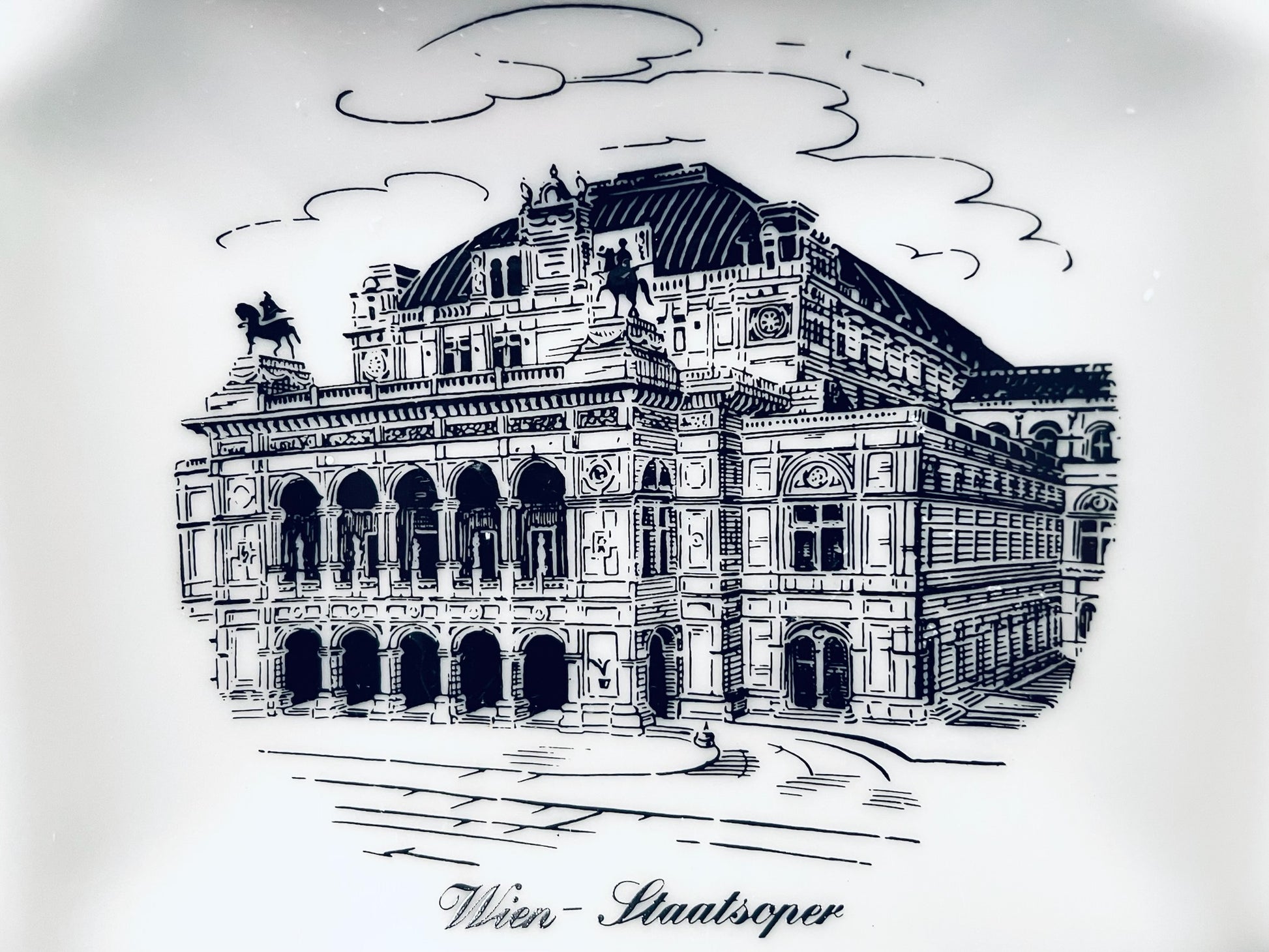 Black and white illustration of a famous opera house with 'Wiener Staatsoper' text below.