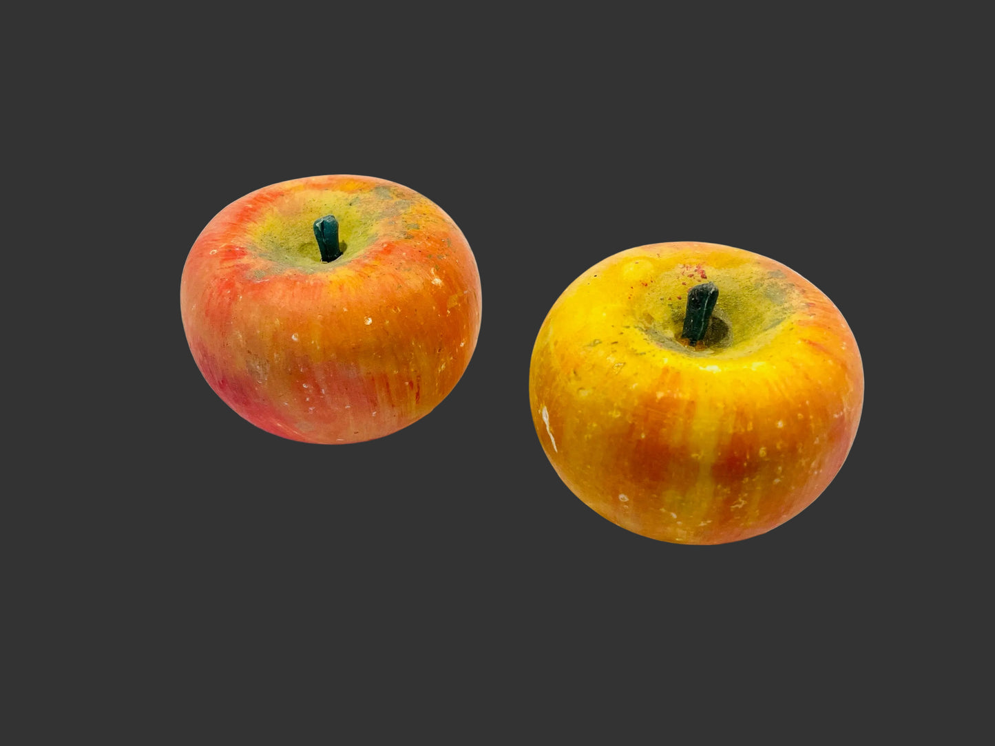 Two life size stone apples with stems 