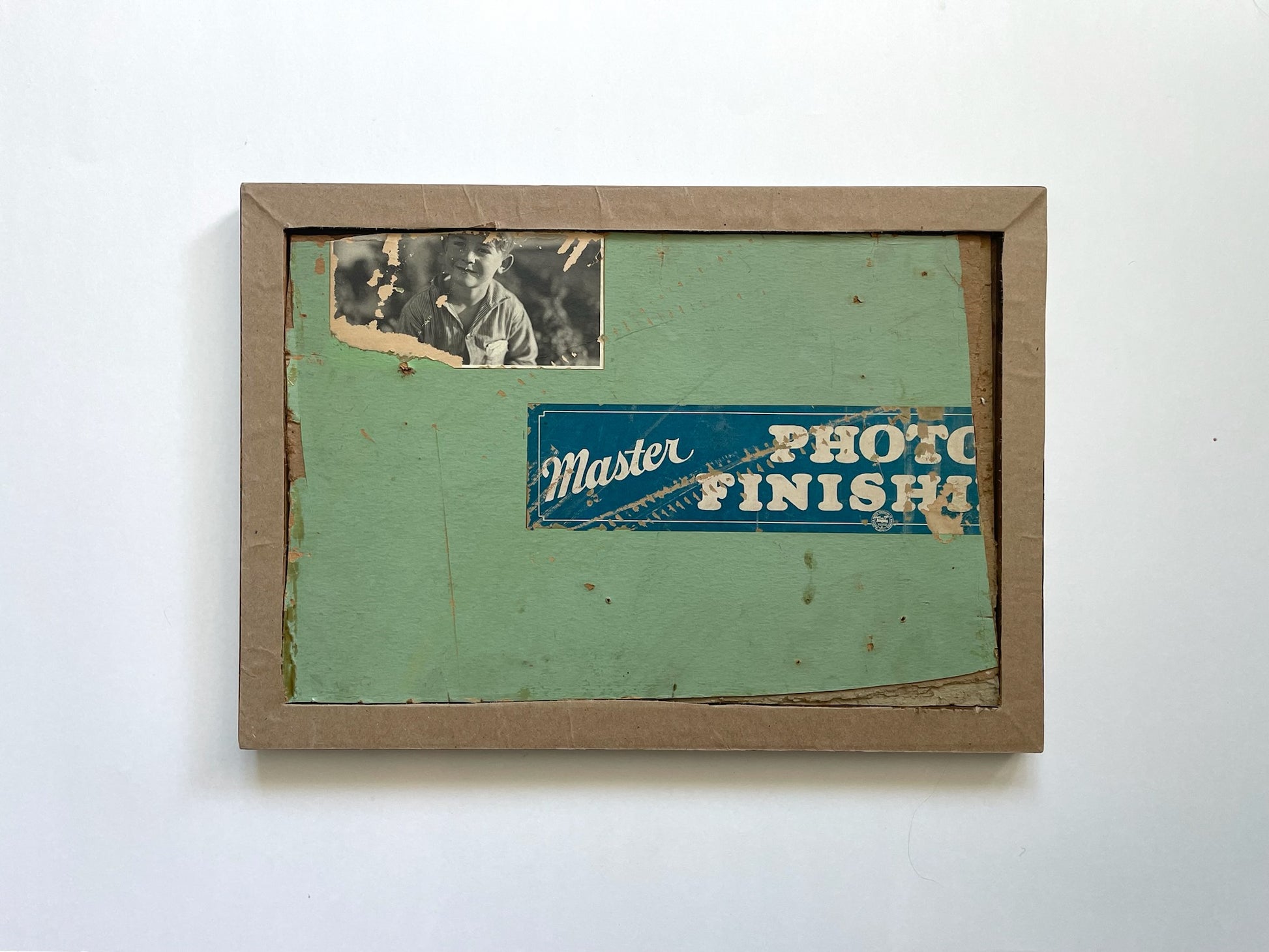 Vintage photo frame with a green backer and 'Master Photo Finish' label on a white background