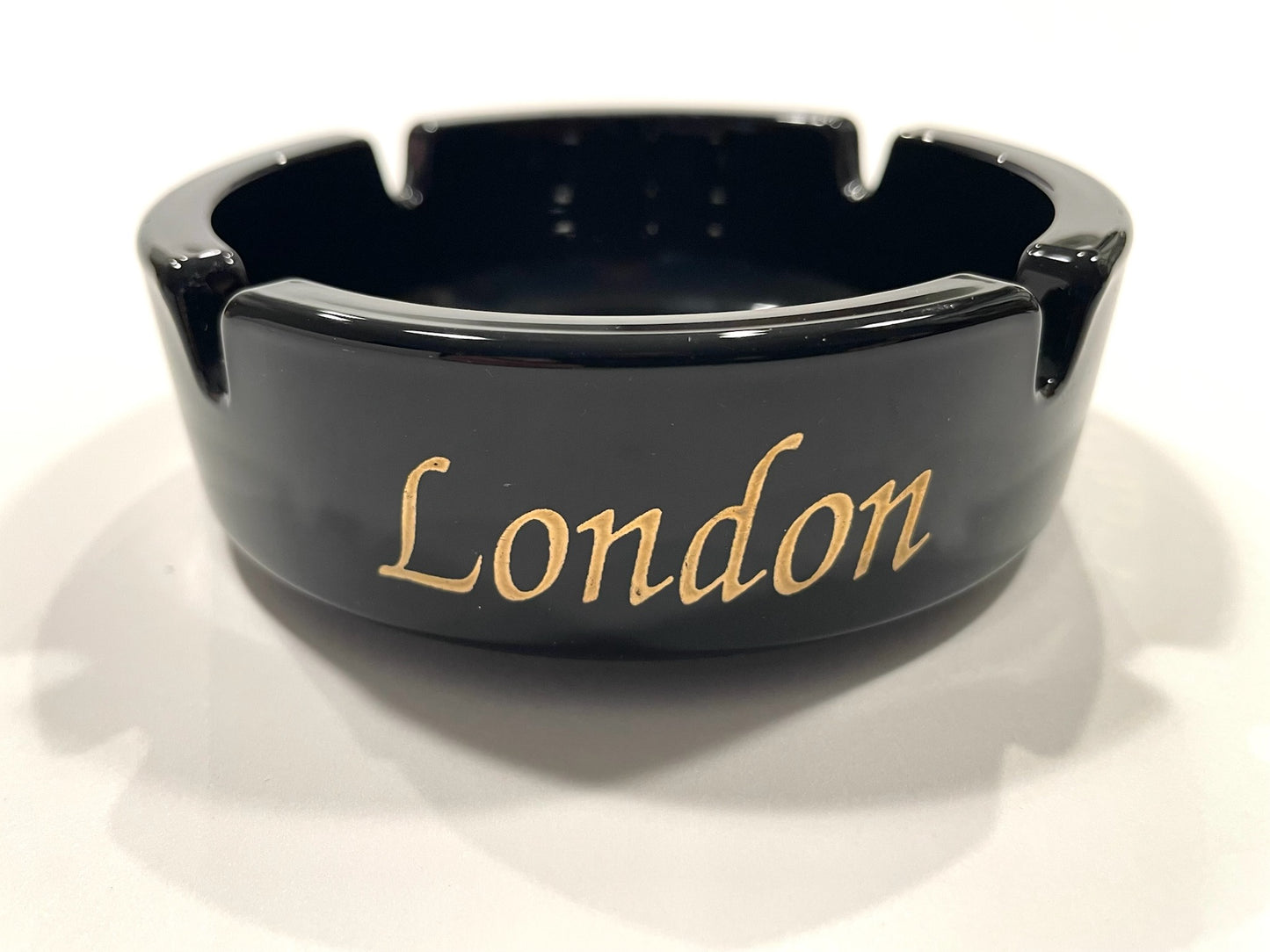 Black ashtray with 'London' written in gold 