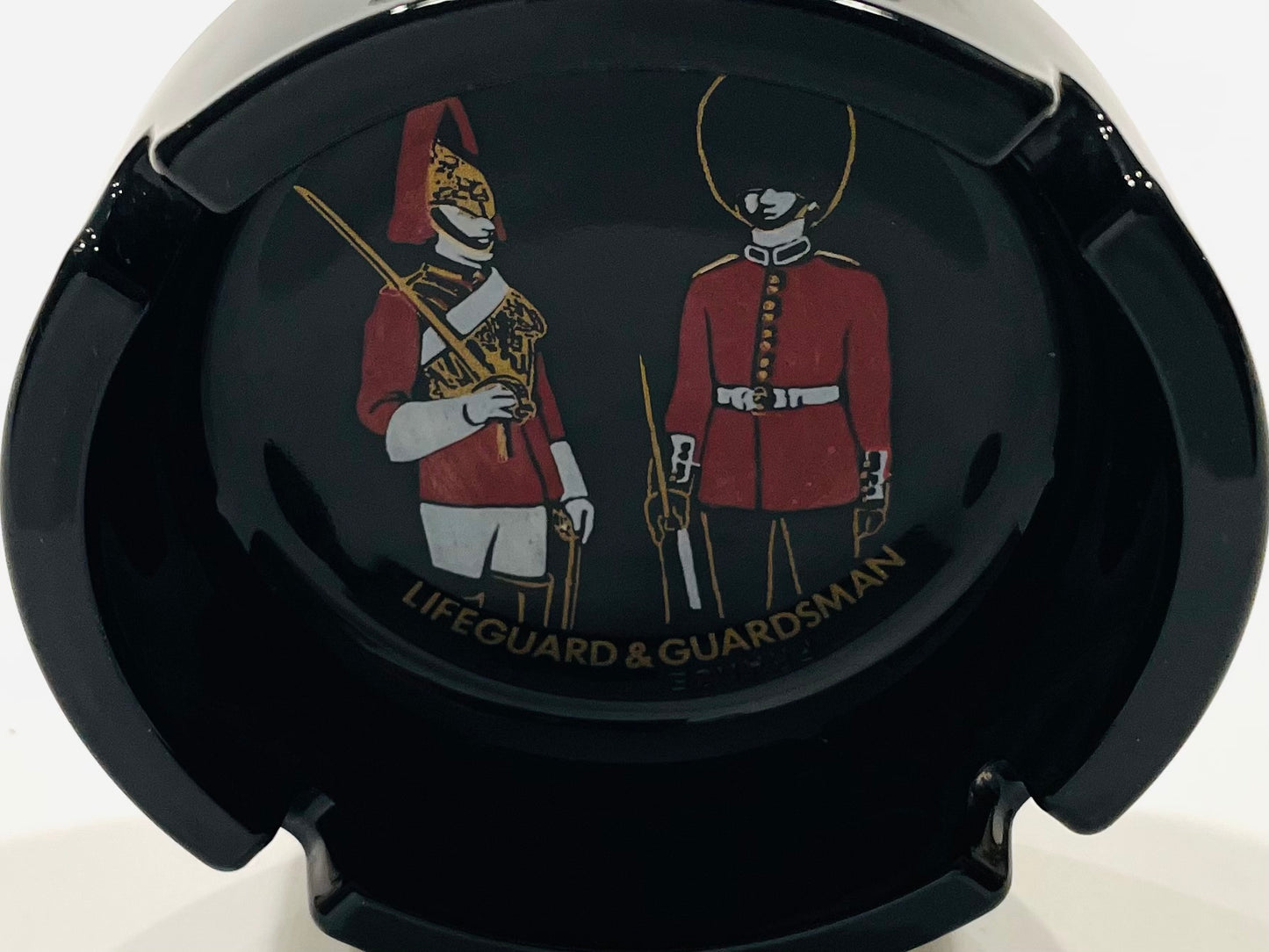 Black car air freshener with illustrations of a 'Lifeguard' and 'Guardsman' in red uniforms.