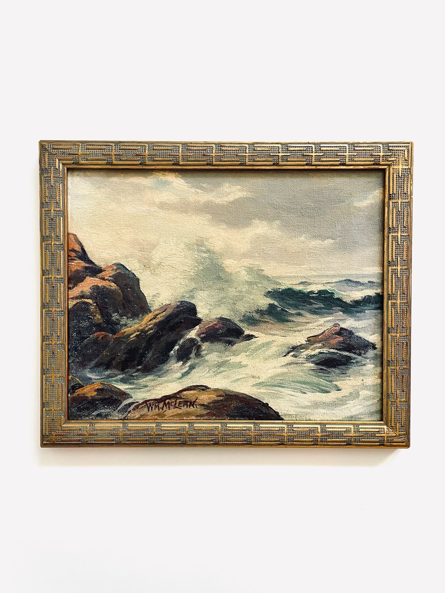 WM Mclean Framed painting of a coastal scene with rocks and waves 