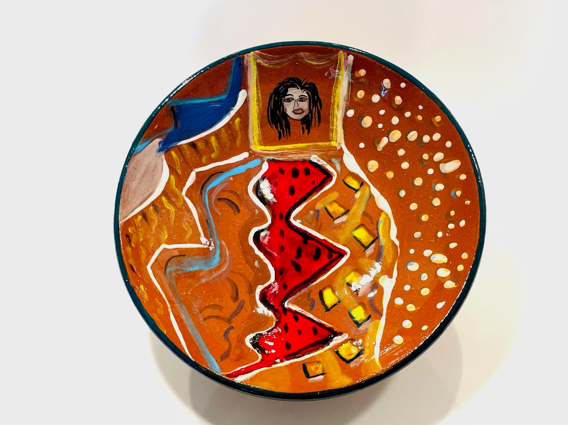Decorative plate with abstract designs and a portrait with artist's signature 