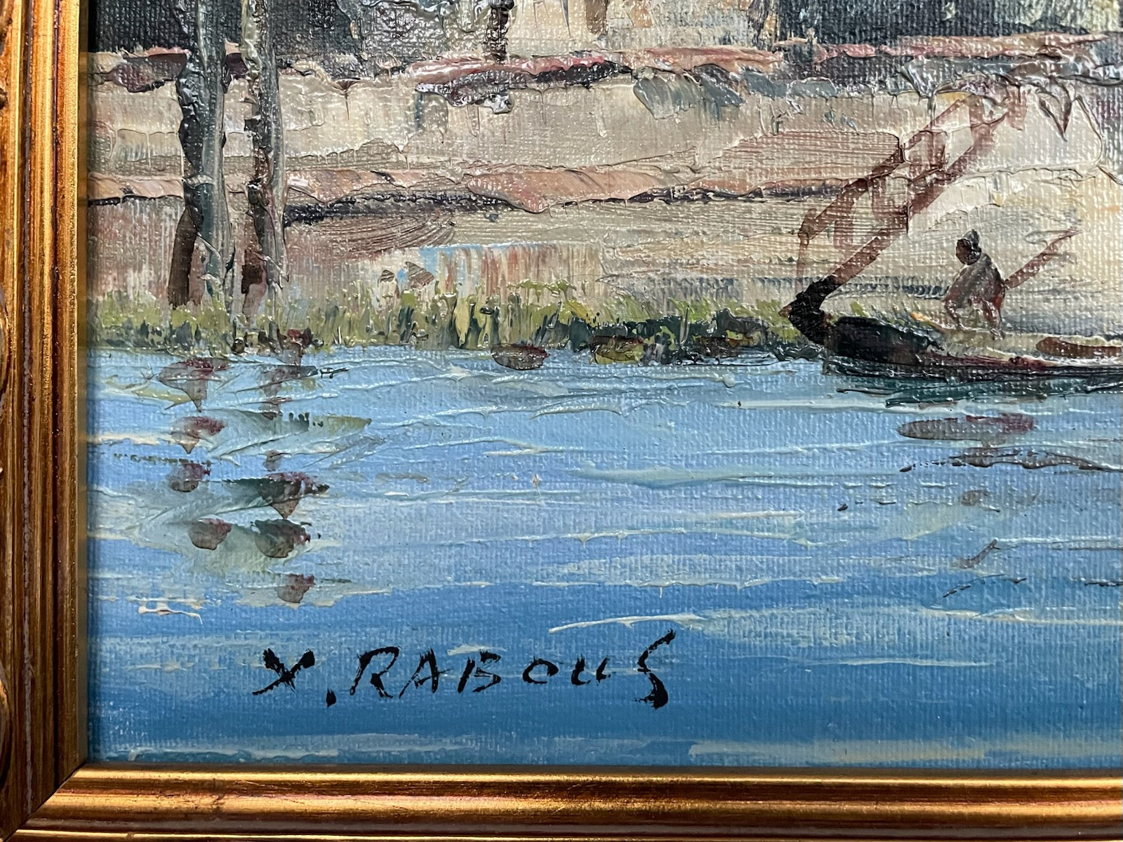 Artistic depiction of a landscape with water and reflections, signed 'X. Rabouls'.