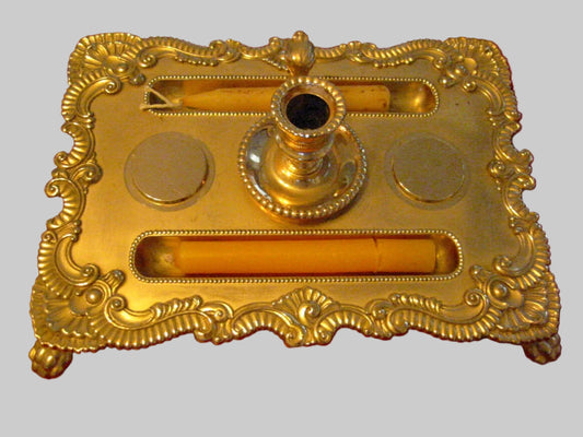 A vintage brass clawfoot candle tray  stamp marked